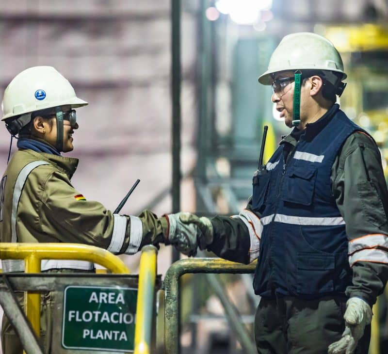 Two Pan American Silver Employees Talking and Shaking Hands