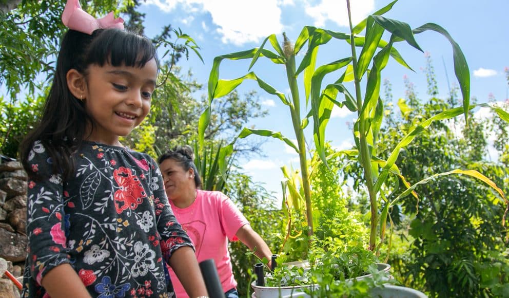 Woman and Girl Working Amongst Greenery